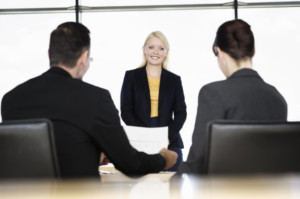 business woman being interviewed by business peopl