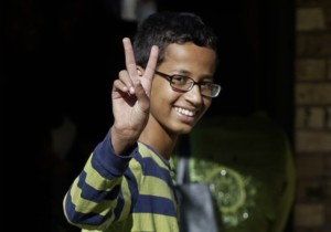 FILE - In this Sept. 17, 2015, file photo, Ahmed Mohamed gestures as he arrives to his family's home in Irving, Texas. The family of the 14-year-old Muslim boy who got in trouble over a homemade clock mistaken for a possible bomb has withdrawn the boy from his suburban Dallas high school Monday, Sept. 21. (AP Photo/LM Otero, File)